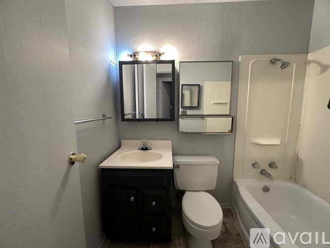 A bathroom with a sink, toilet, and bathtub.