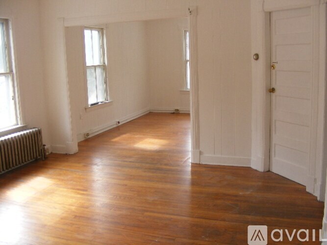 A room with wooden floors and white walls.