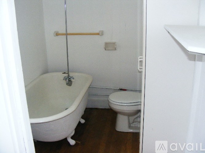 A white bathroom with a toilet and a bathtub.