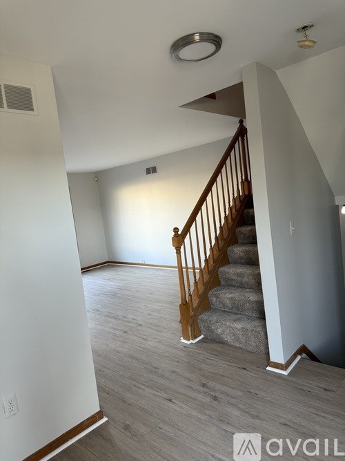A room with a staircase and a light on the ceiling.
