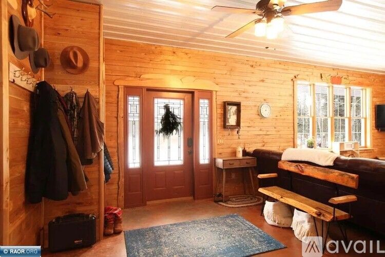 A room with wooden walls and a ceiling fan.