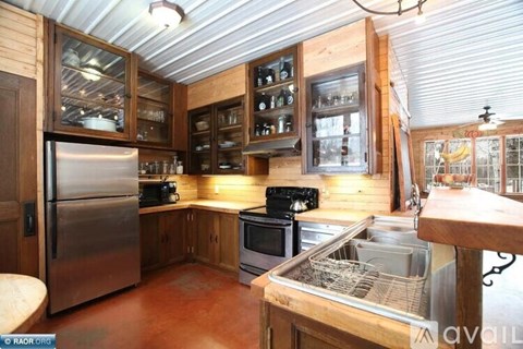A kitchen with wooden cabinets and stainless steel appliances.