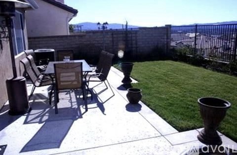 A patio with chairs and a table is shown.