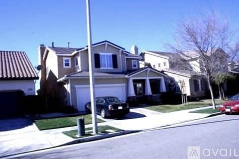 A house with a car parked in front of it.