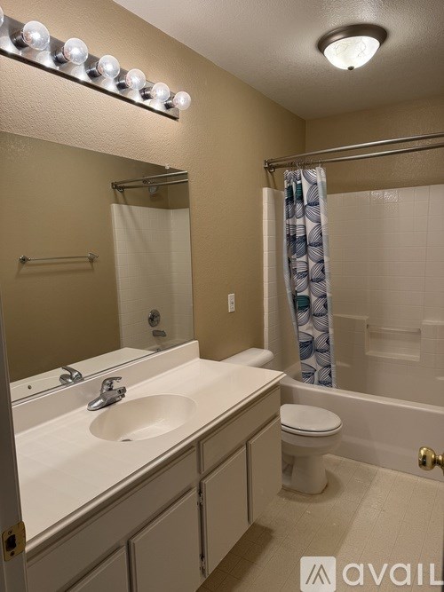 A bathroom with a white sink and a toilet.
