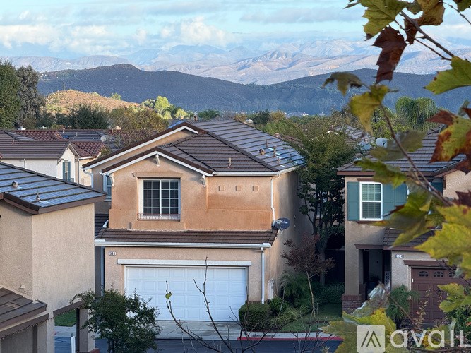 A house with a mountain view in the background.