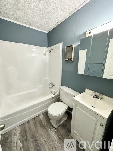 A bathroom with a white toilet and sink.