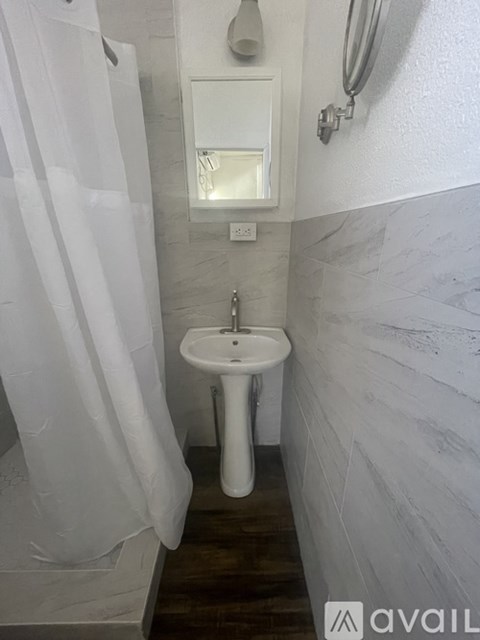 A white sink in a small bathroom.