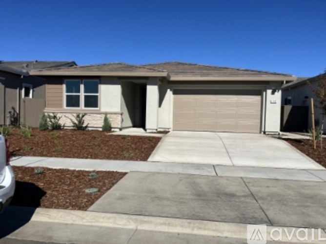 A house with a garage and a driveway in front.