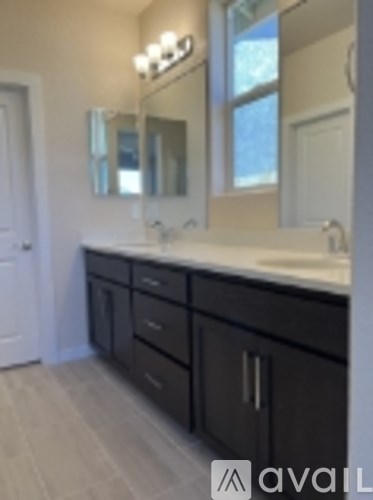 A bathroom with a sink and mirror.