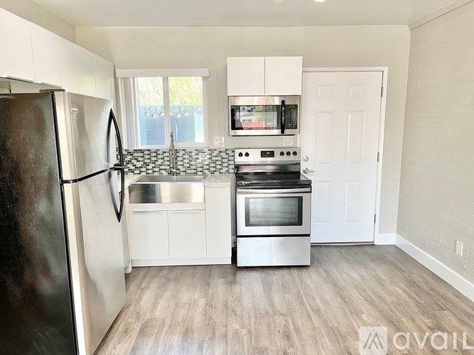 A kitchen with a refrigerator, stove, and oven.