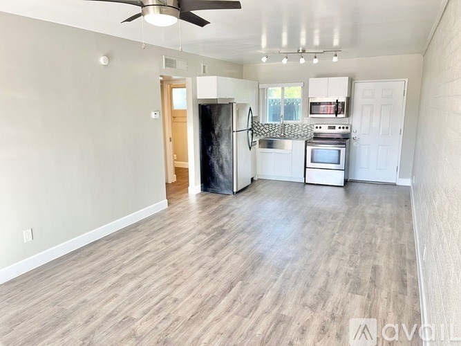 A spacious kitchen with a refrigerator, oven, and microwave.