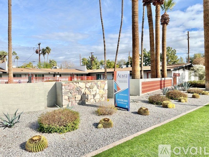 A sign in front of a building that says "Acura".