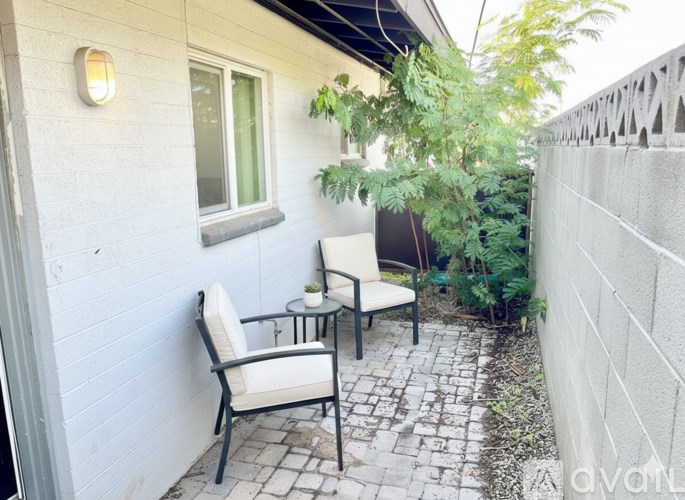 A patio with a chair and a table.