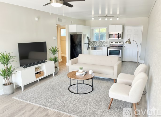 A modern living room with a television, sofa, and coffee table.