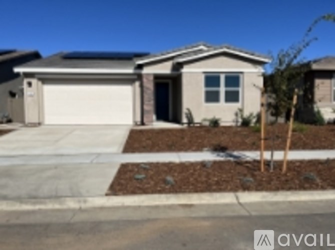 A house with a garage door and a window is for sale.