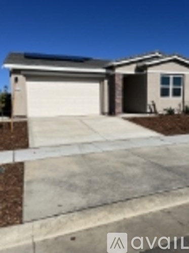 A house with a garage door and a driveway.