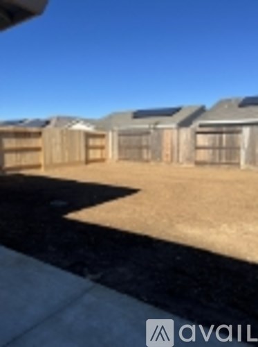 A row of houses with a clear blue sky in the background.