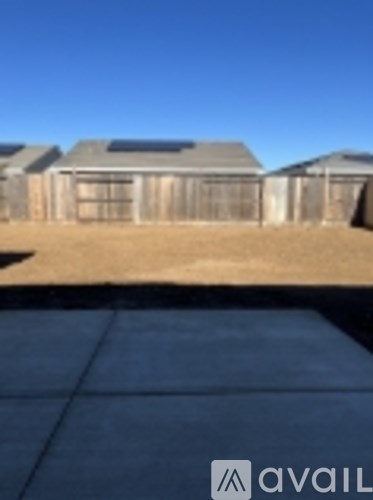 A house with a brown roof and a brown fence.