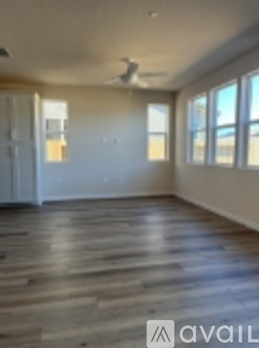 A room with wooden flooring and a window.