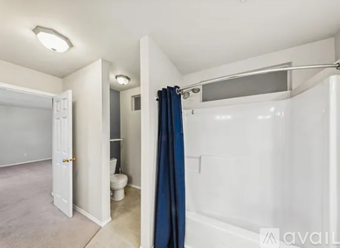 A bathroom with a toilet, sink, and shower.