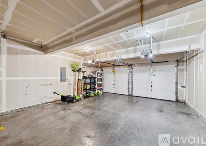 A large, empty warehouse with a concrete floor and white walls.