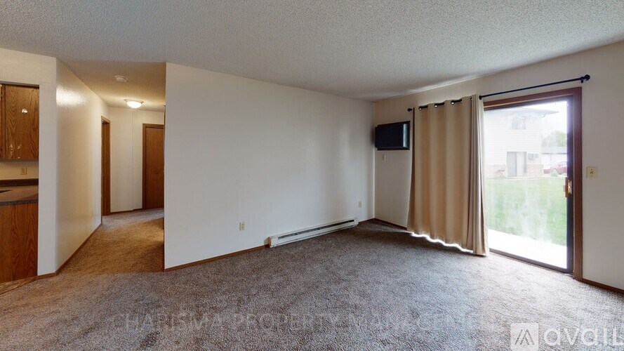 A living room with a sliding glass door leading to a balcony.