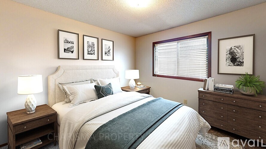 A bedroom with a large bed, two nightstands, and a window with blinds.
