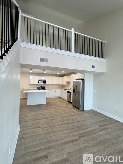 A modern kitchen with a refrigerator, stove, and oven.