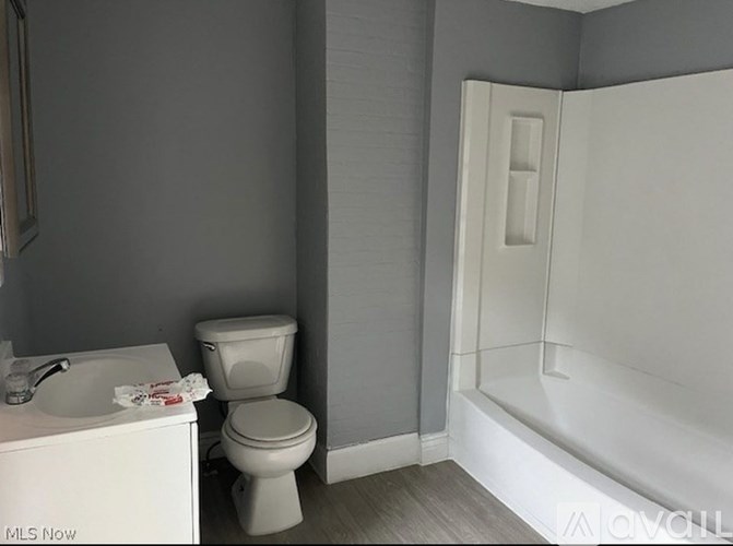 A white toilet sits next to a sink in a bathroom.