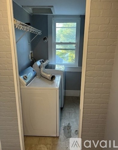 A small bathroom with a toilet and a window.