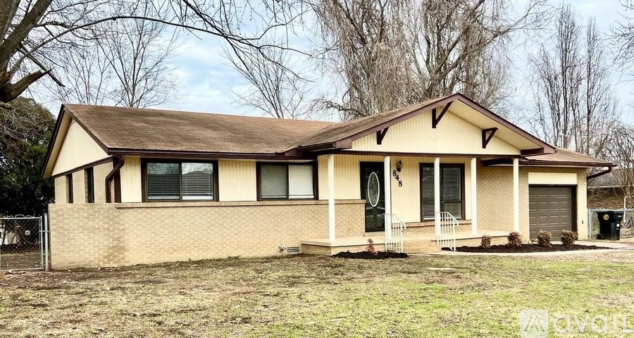 A house with a brown roof and a white garage door.
