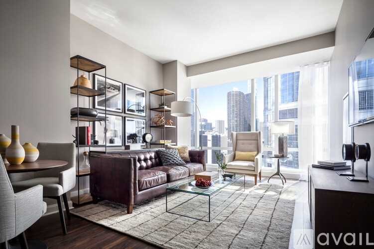 A modern living room with a brown leather sofa and a glass coffee table.