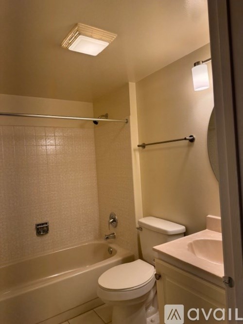 A bathroom with a toilet, sink, and bathtub.