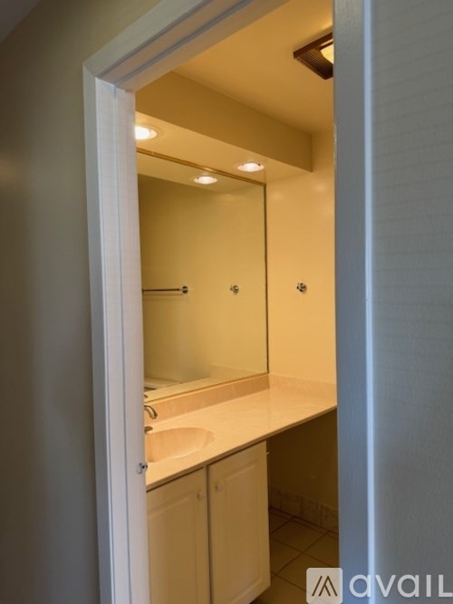 A bathroom with a sink and mirror.