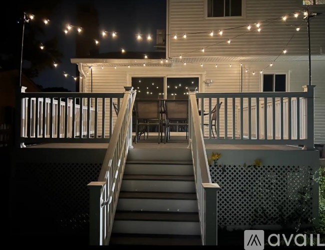A house with a deck and stairs leading to it.