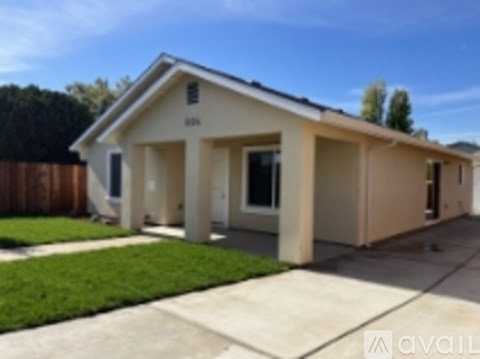 A house with a brown fence in front of it.