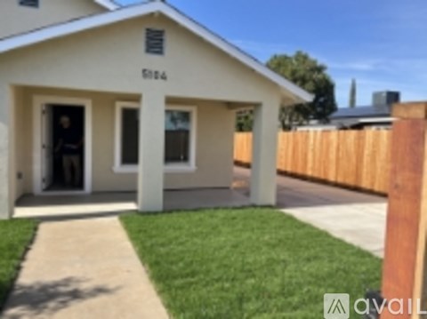 A small white house with the number 6164 on the front.