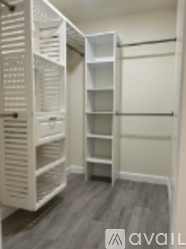 A white closet with shelves and drawers.