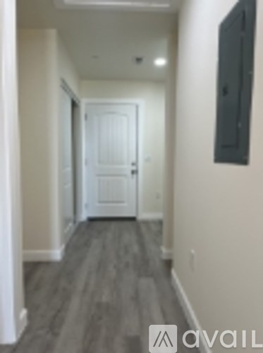 A hallway with a door at the end.