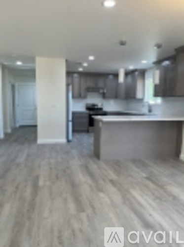 A kitchen with a counter and a refrigerator.