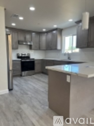 A kitchen with a black stove top oven and a white counter top.