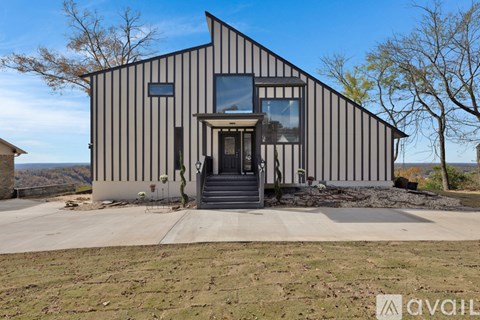 A modern house with a striped facade and a glass door.