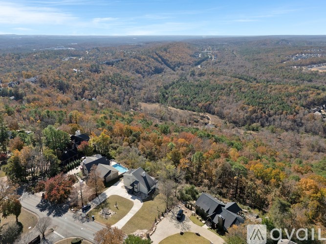 A bird's eye view of a residential area with houses and trees.