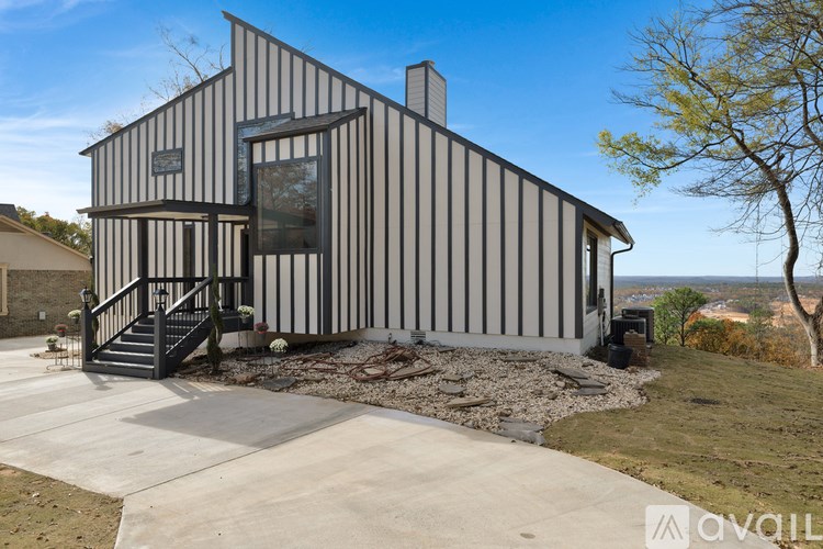 A modern house with a striped exterior and a black staircase leading to the entrance.