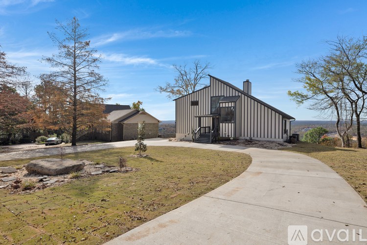 A modern house with a concrete pathway leading to the entrance.