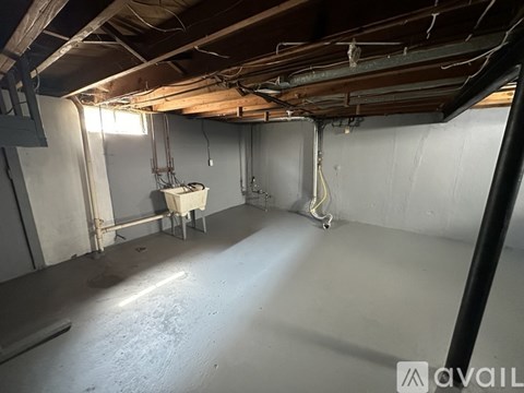 A room with a lot of pipes and a table in it.