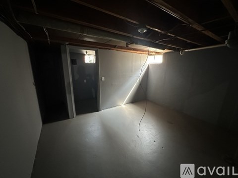 A room with a door and a window, with a light source coming from the window.