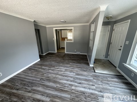A room with grey walls and a wooden floor.