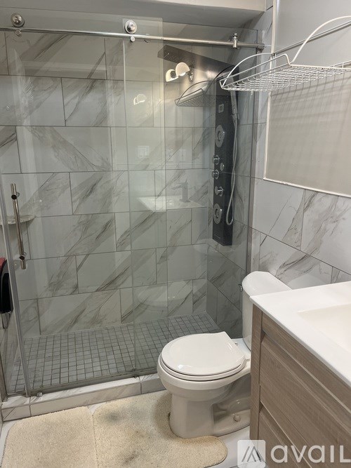 A white toilet in a bathroom with a glass shower door.